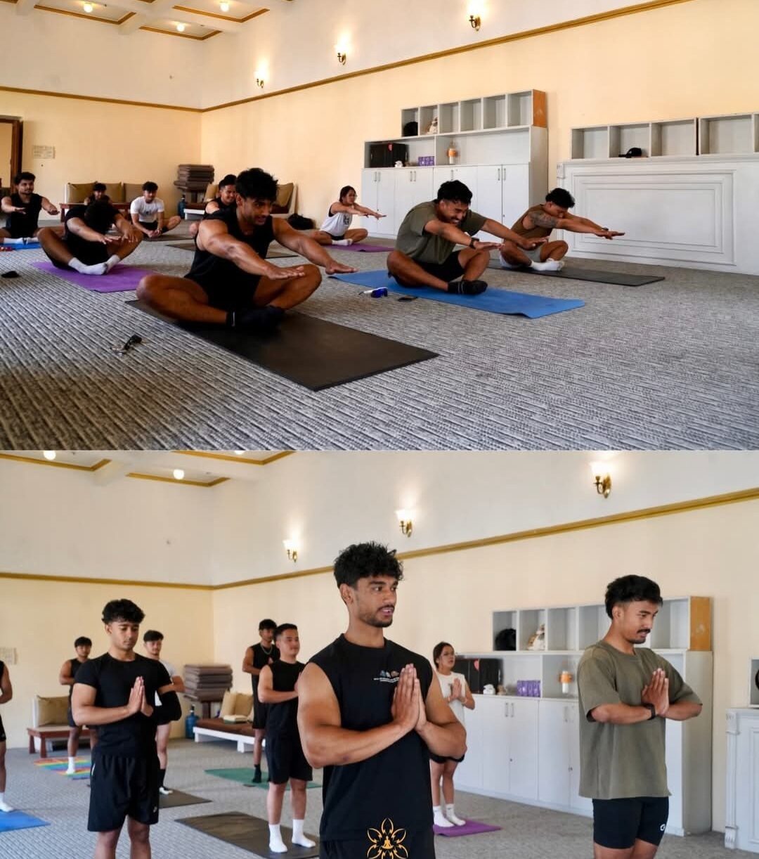 Group yoga class standing in mountain pose inside the studio