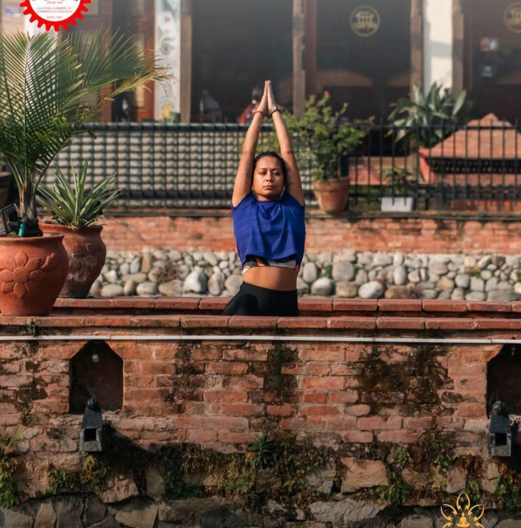 Prayer pose above a heritage stone water tank