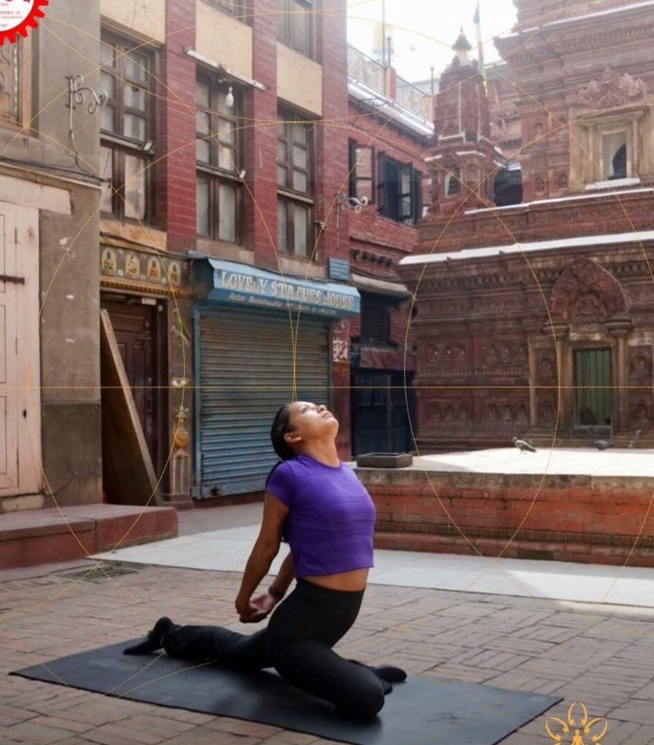 A practitioner moving through yoga in a Patan heritage courtyard, brick temples behind